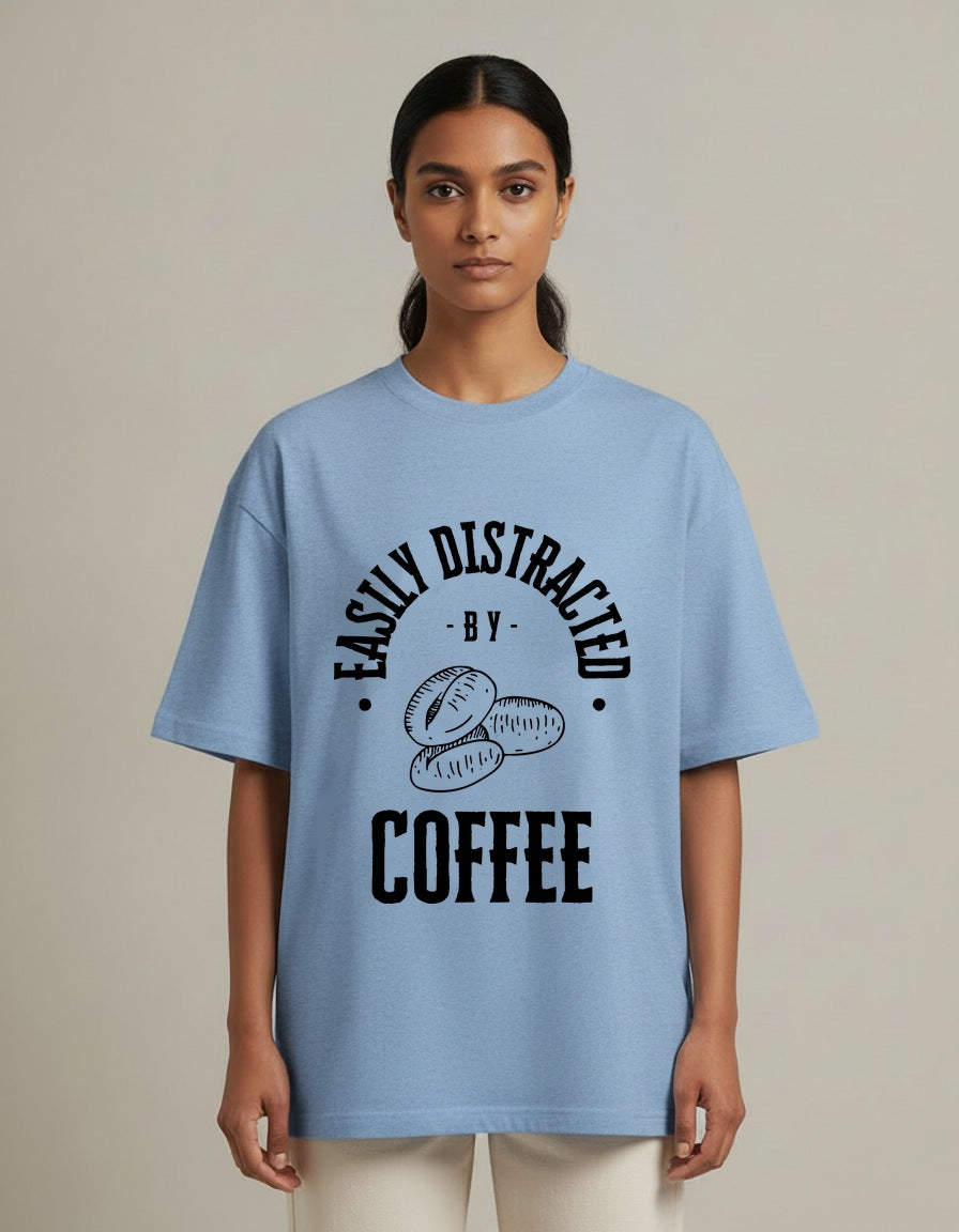 Distracted by Coffee - Light - Baby Blue - Chapter26 premium oversized graphic t-shirt, worn by a female model