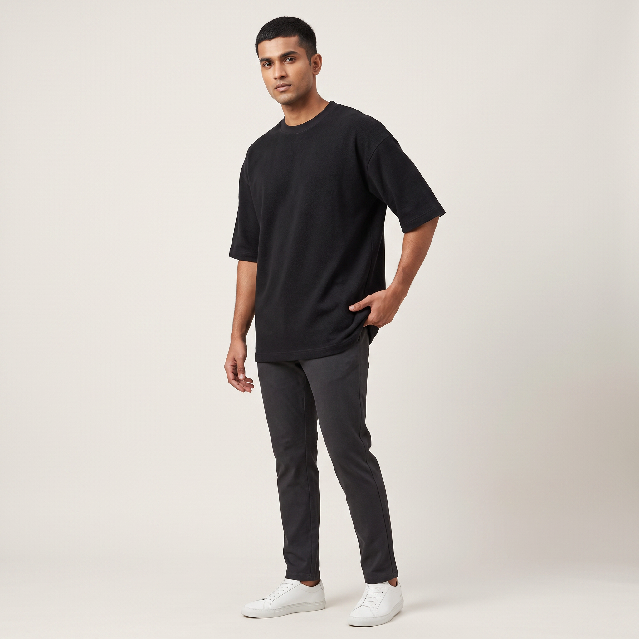 Model wearing Basic Black oversized t-shirt, front three-quarter view
