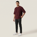 Model wearing Mega Maroon oversized t-shirt, front three-quarter view