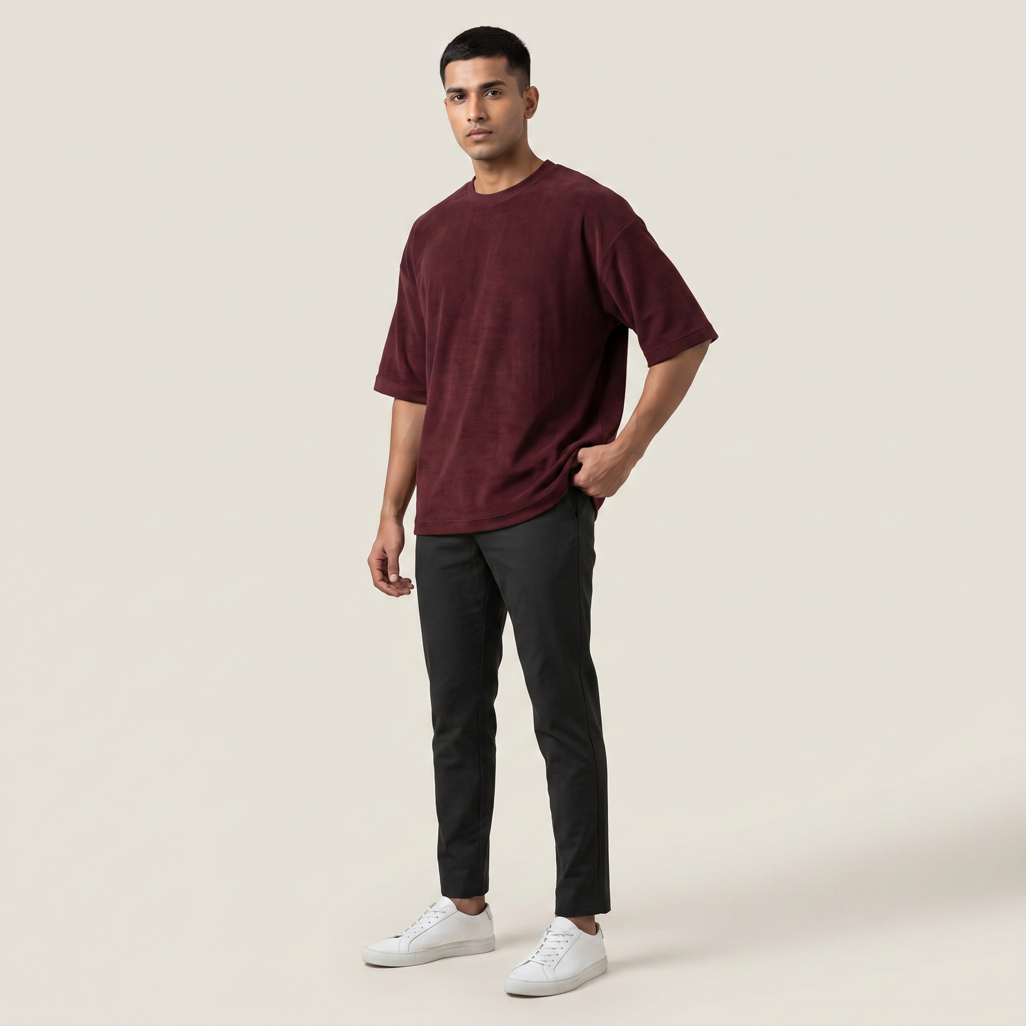 Model wearing Mega Maroon oversized t-shirt, front three-quarter view