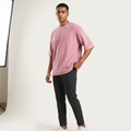 Model wearing Plush Pink oversized t-shirt, front three-quarter view