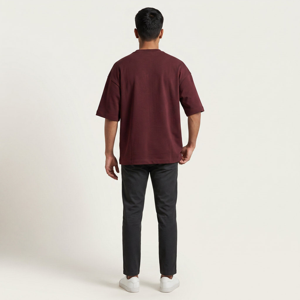 Model wearing Mega Maroon oversized t-shirt, back view
