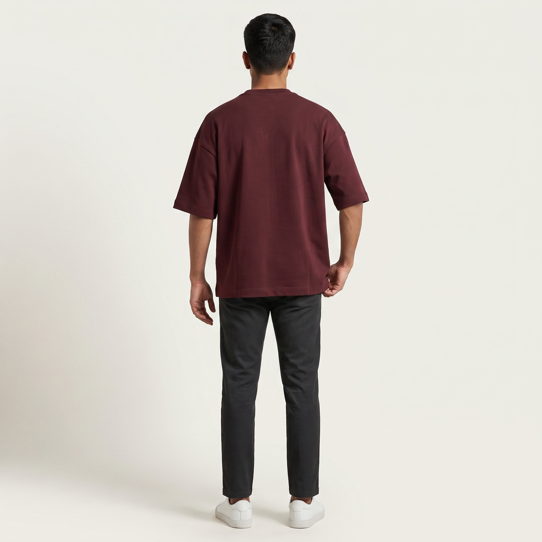 Model wearing Mega Maroon oversized t-shirt, back view