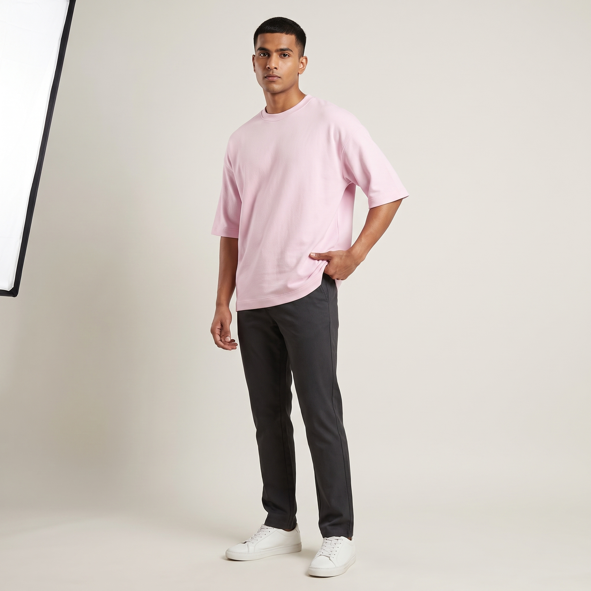 Model wearing Baby Pink oversized t-shirt, front three-quarter view