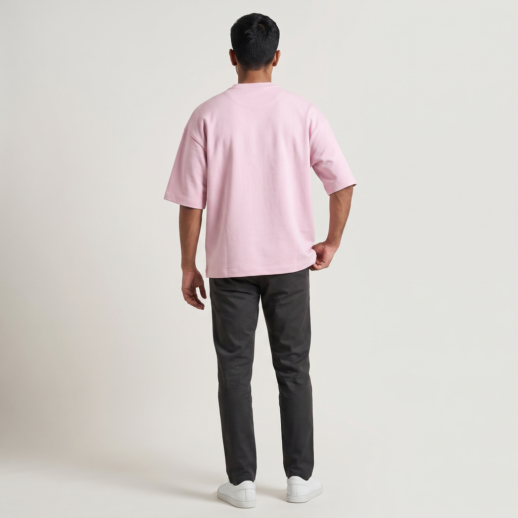 Model wearing Baby Pink oversized t-shirt, back view