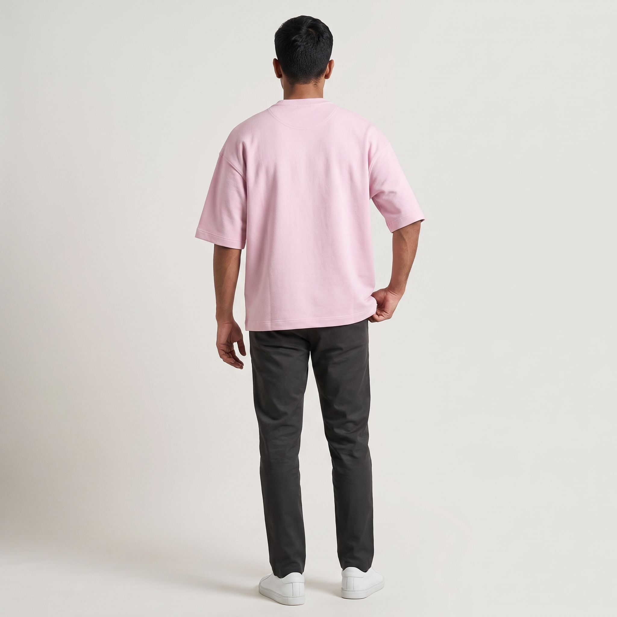 Model wearing Baby Pink oversized t-shirt, back view