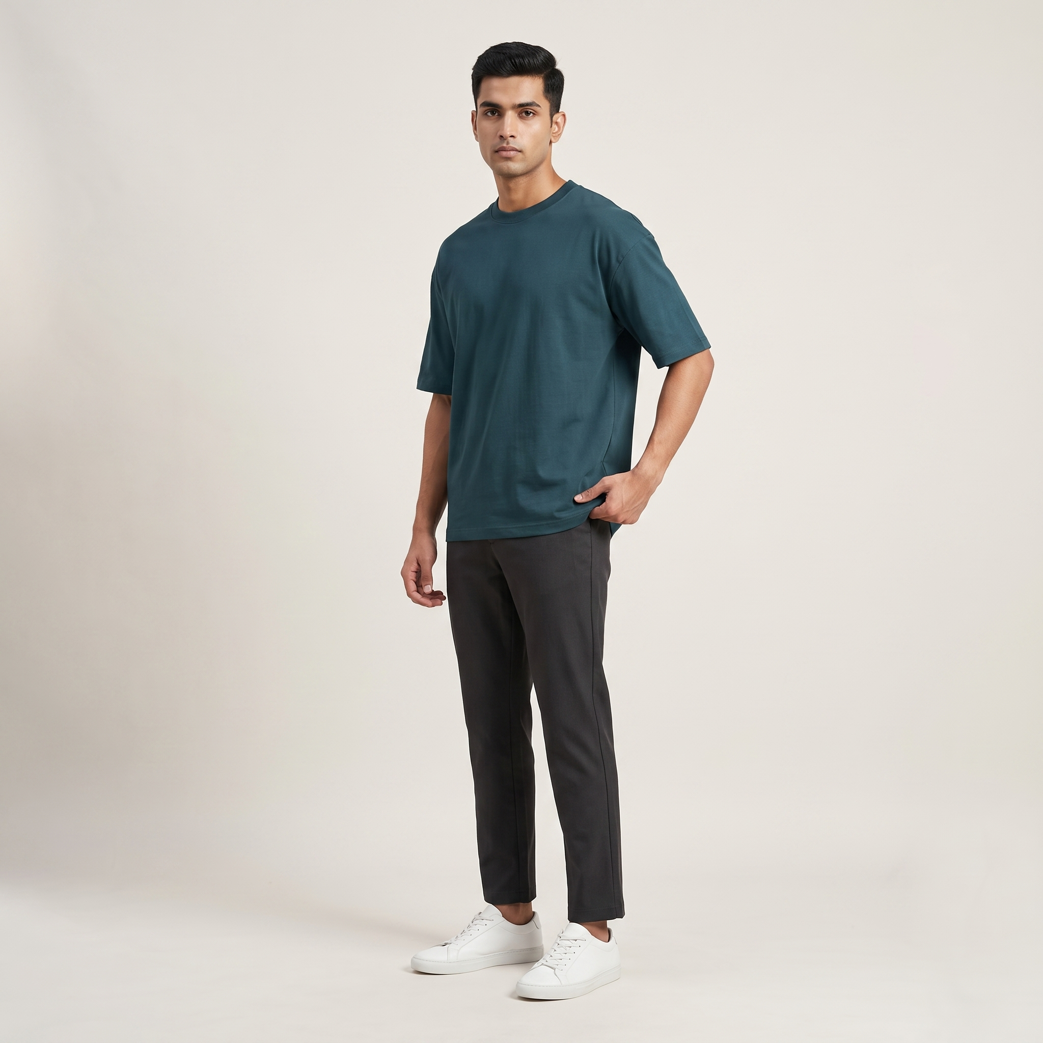 Model wearing Petrol Blue classic oversized t-shirt, front three-quarter view