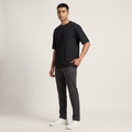 Model wearing Black classic oversized t-shirt, front three-quarter view