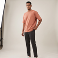Model wearing Coral classic oversized t-shirt, front three-quarter view