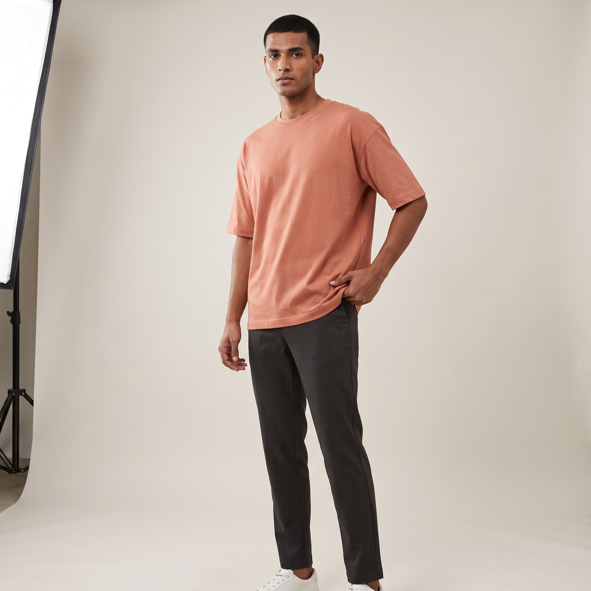 Model wearing Coral classic oversized t-shirt, front three-quarter view