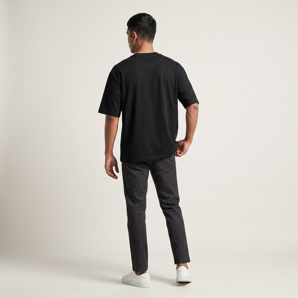 Model wearing Black classic oversized t-shirt, back view