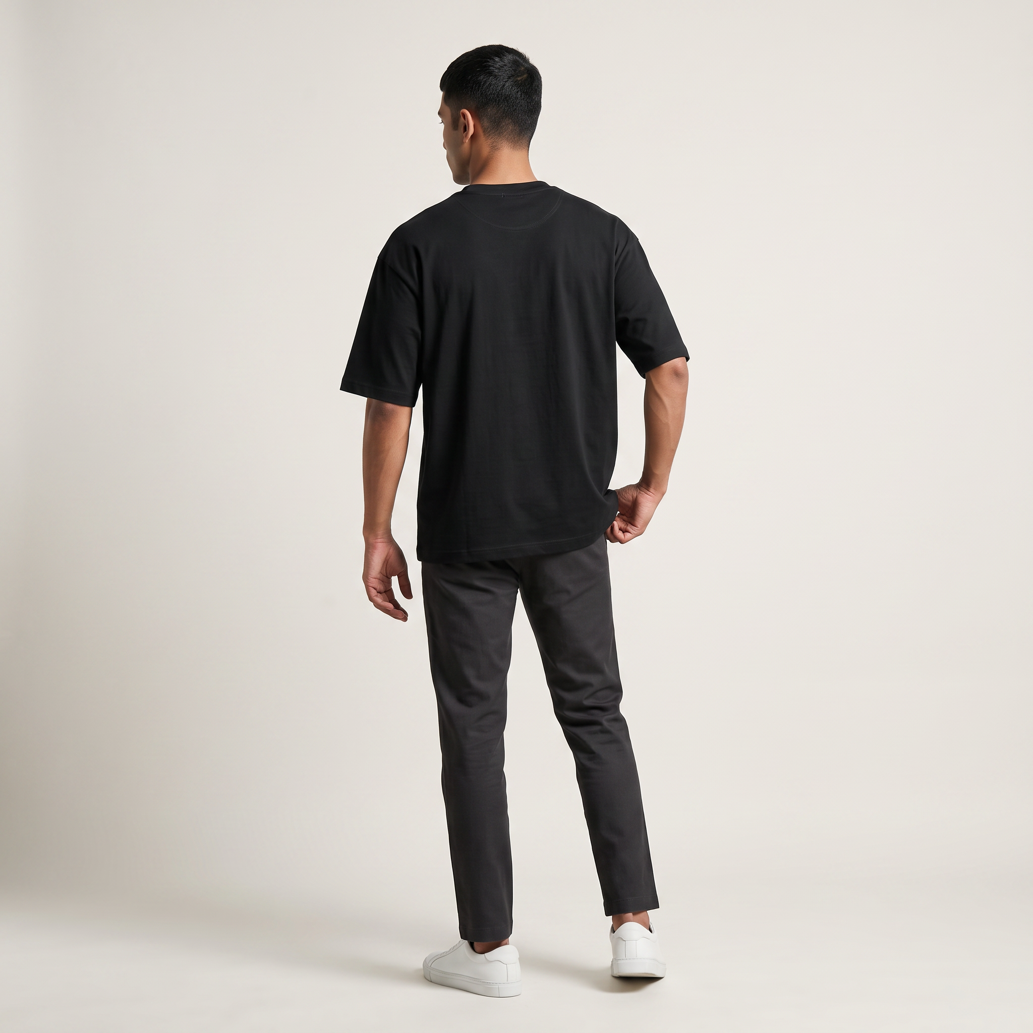 Model wearing Black classic oversized t-shirt, back view