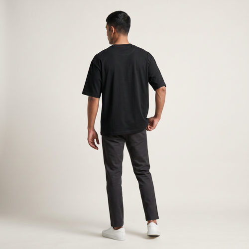 Model wearing Black classic oversized t-shirt, back view