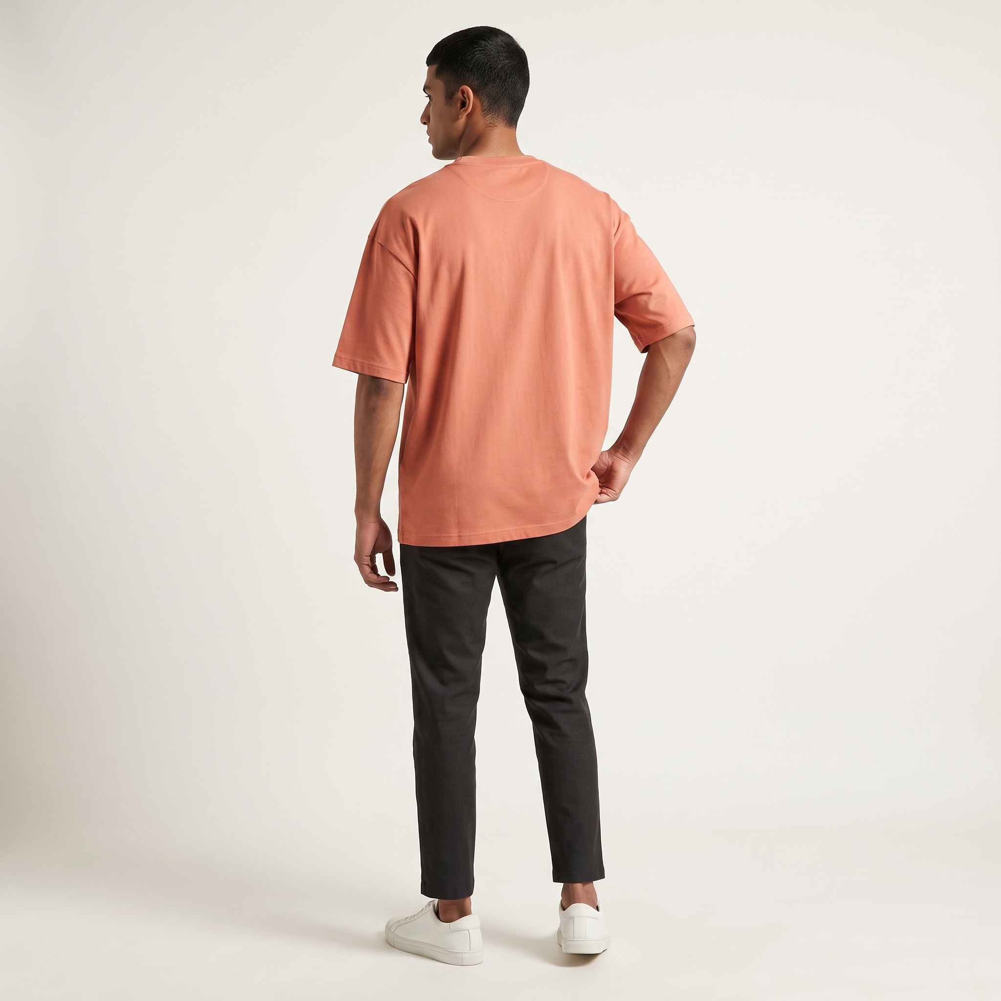 Model wearing Coral classic oversized t-shirt, back view