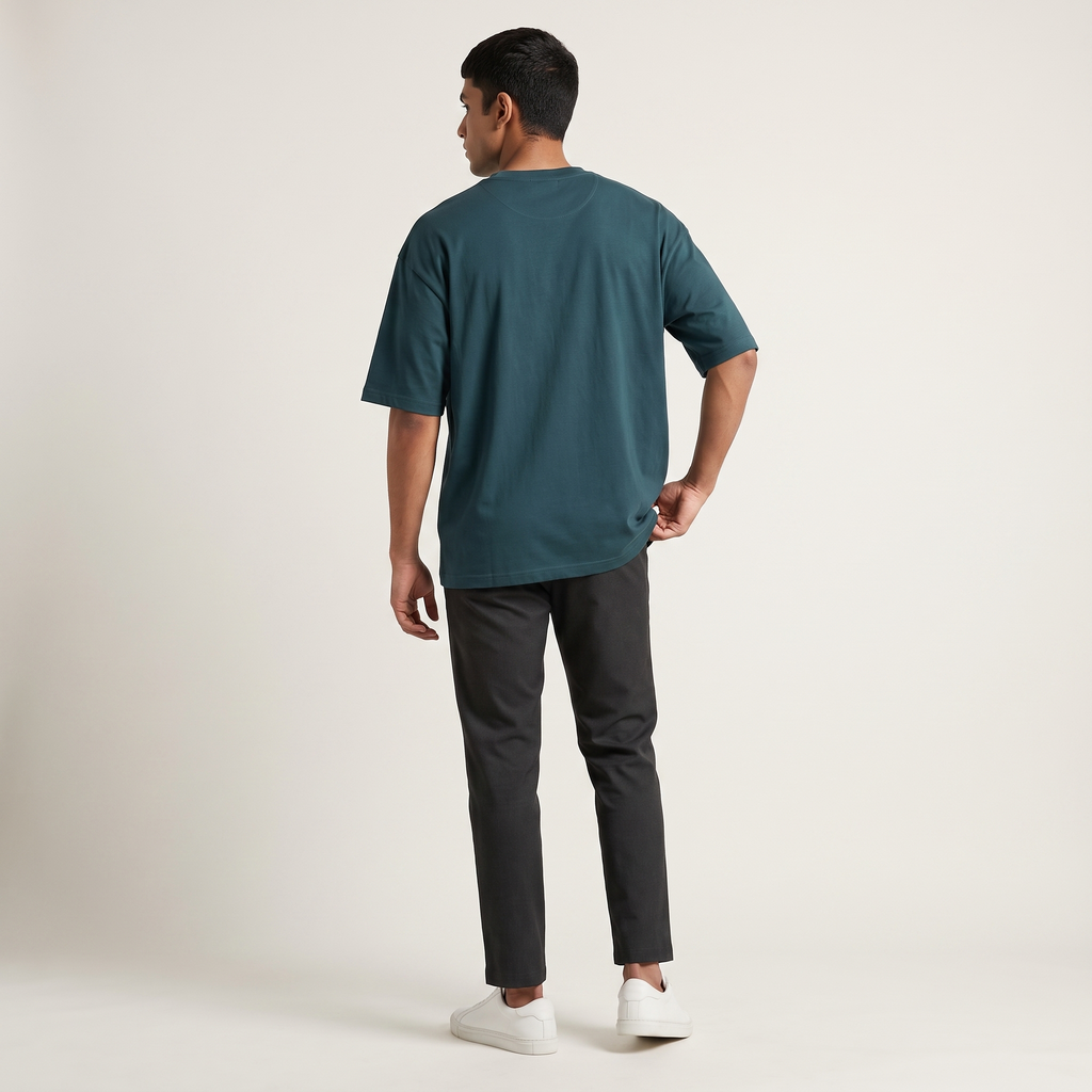 Model wearing Petrol Blue classic oversized t-shirt, back view