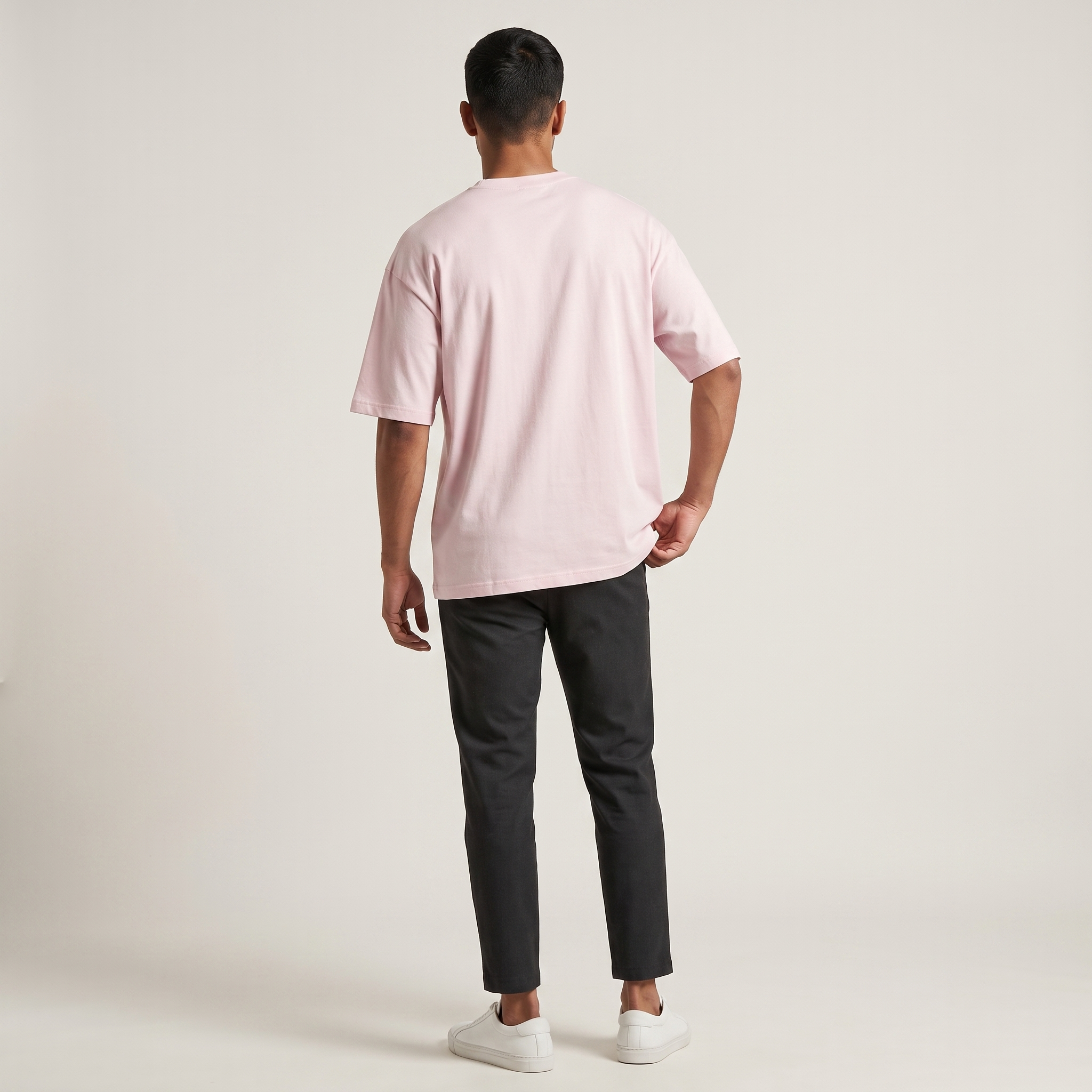 Model wearing Classic Baby Pink oversized t-shirt, back view