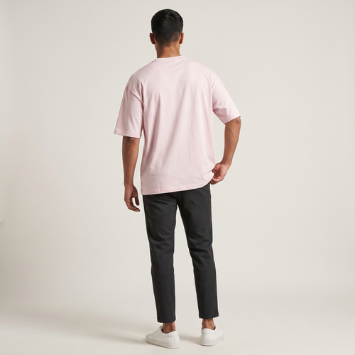 Model wearing Classic Baby Pink oversized t-shirt, back view