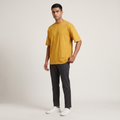 Model wearing Mustard classic oversized t-shirt, front three-quarter view