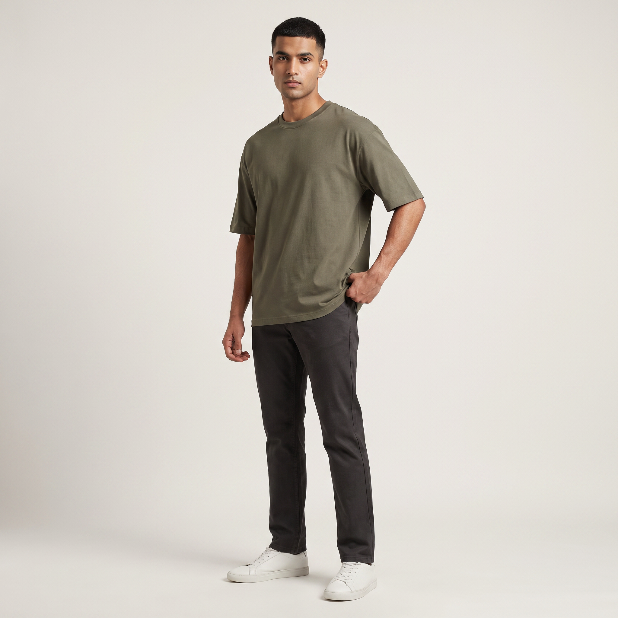 Model wearing Olive classic oversized t-shirt, front three-quarter view