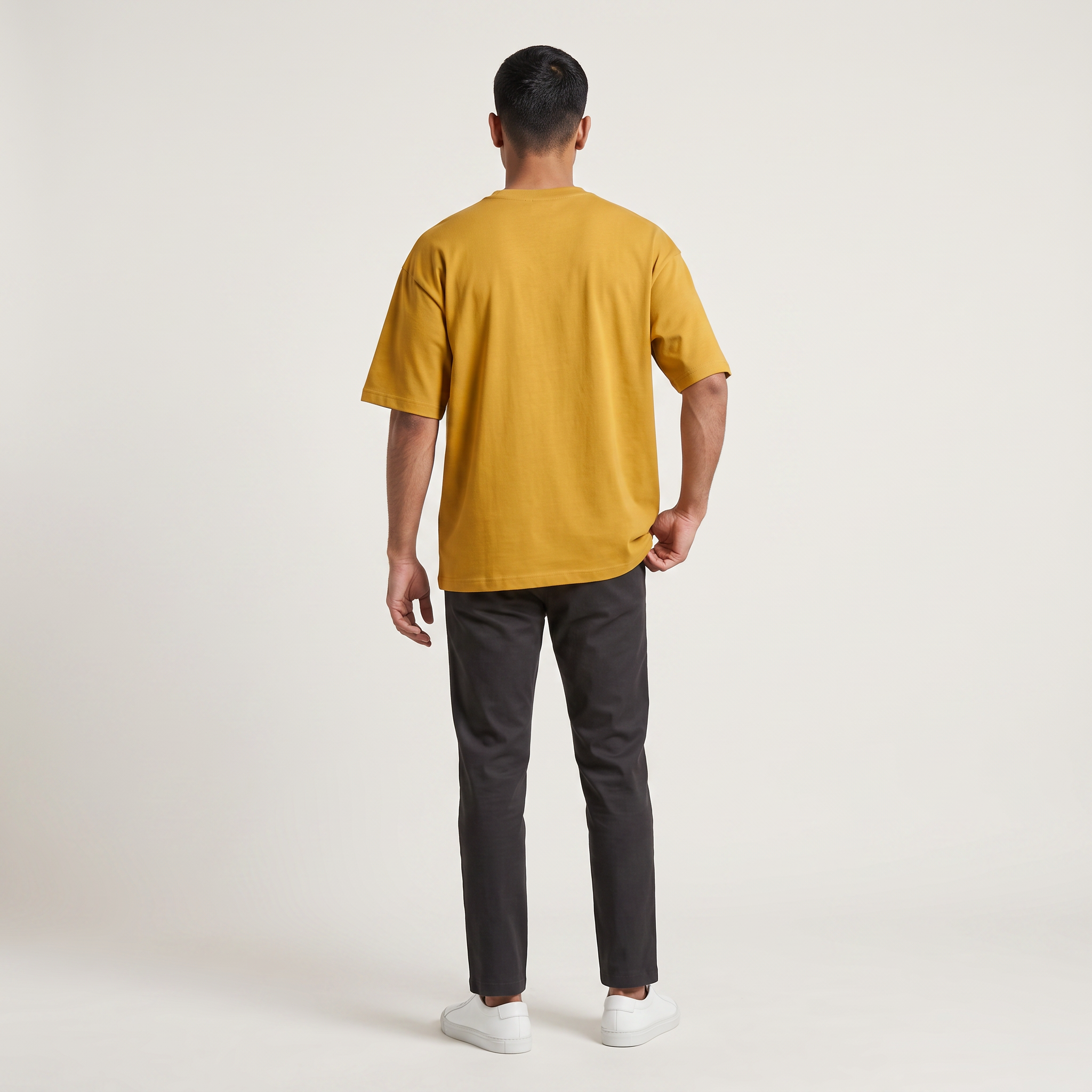 Model wearing Mustard classic oversized t-shirt, back view