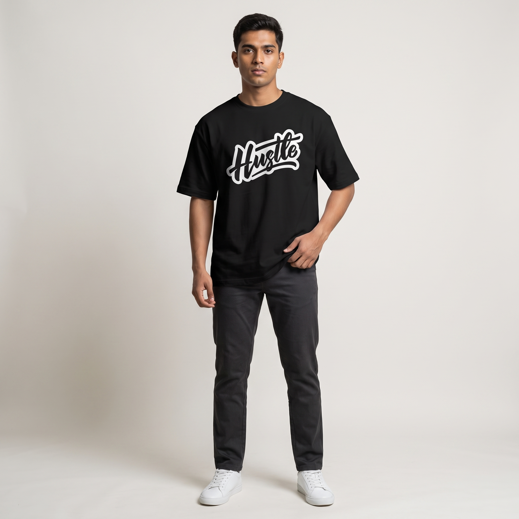Model wearing Hustle Dark oversized t-shirt, front view showing chest print