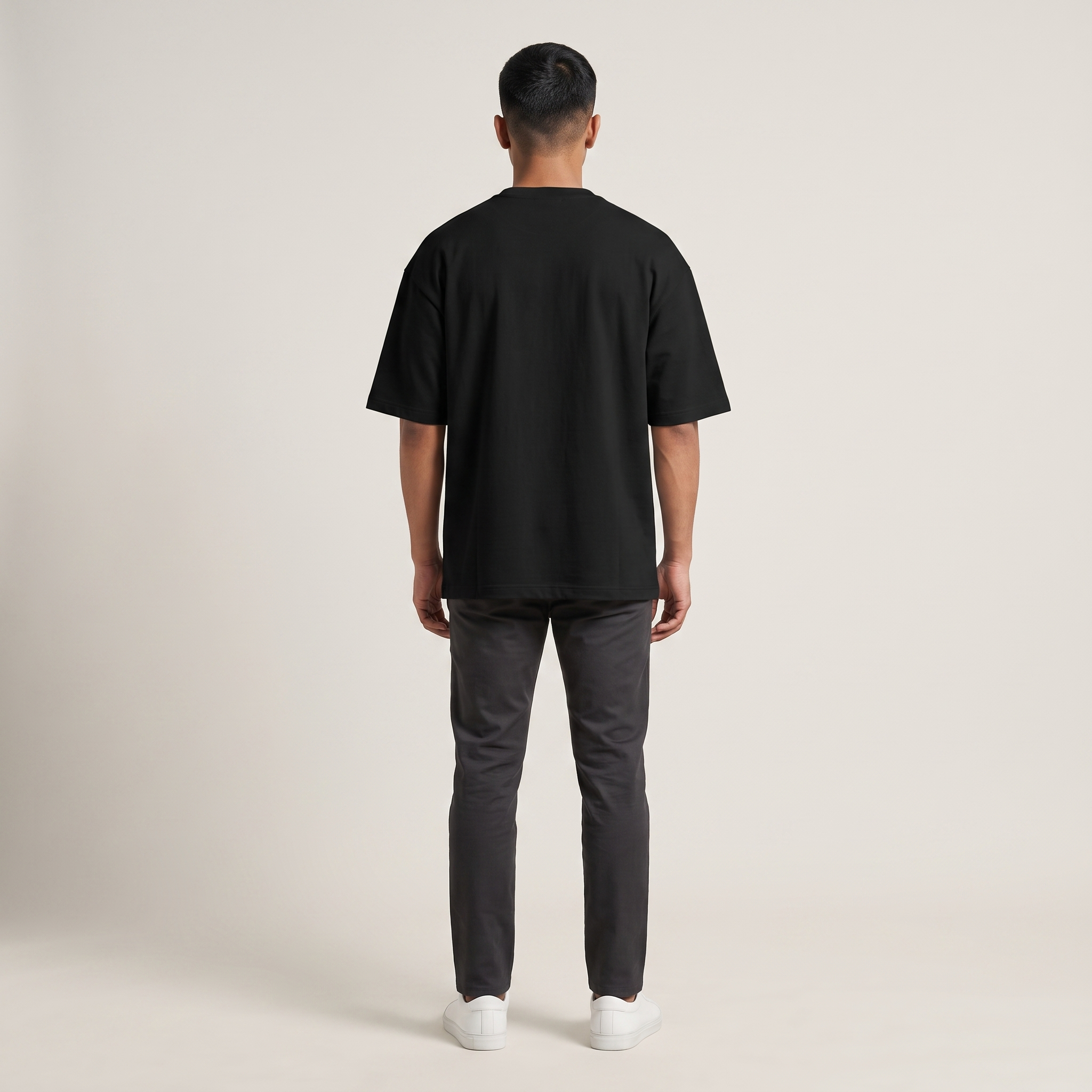 Model wearing Elementary Coffee oversized t-shirt, back view