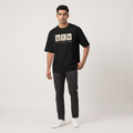 Model wearing Elementary Coffee oversized t-shirt, front view showing chest print