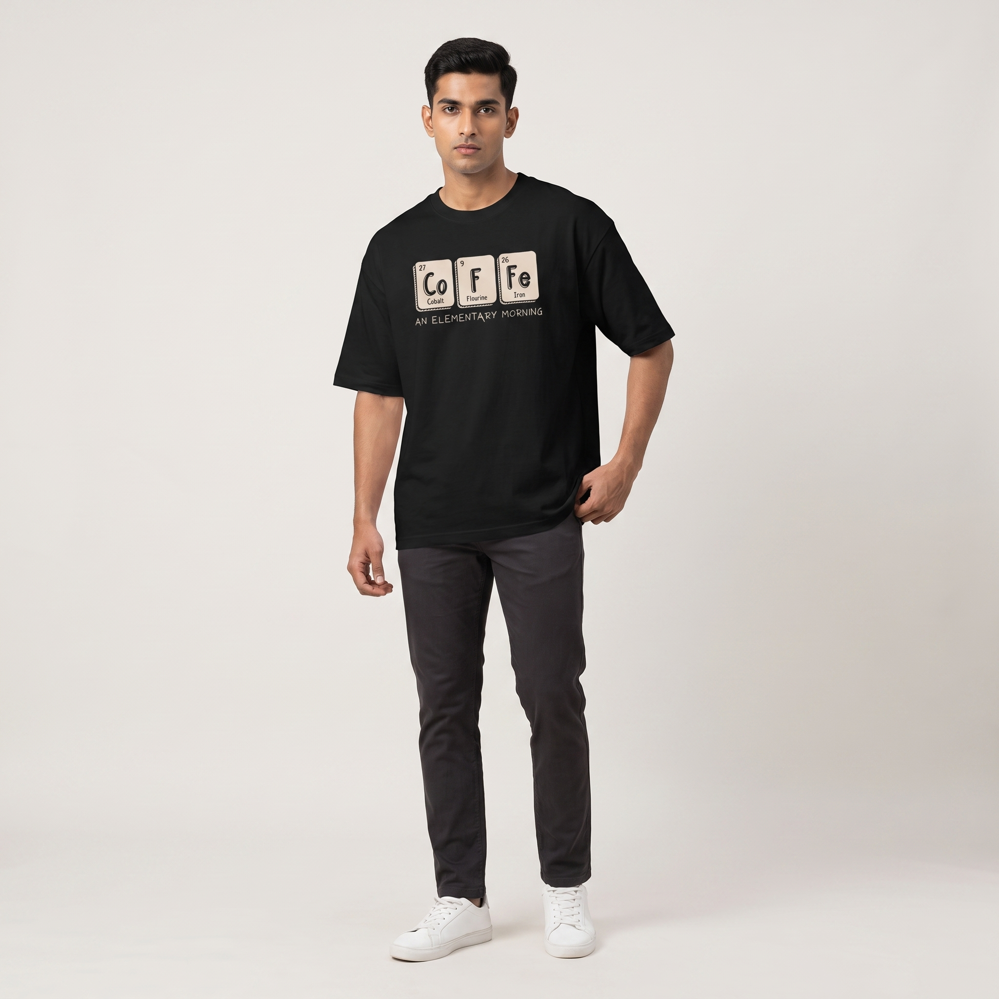 Model wearing Elementary Coffee oversized t-shirt, front view showing chest print