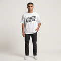 Model wearing Hustle Light oversized t-shirt in white, front view showing chest print