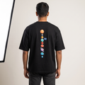 Model wearing Universal Welcome oversized t-shirt, back view showing solar system print