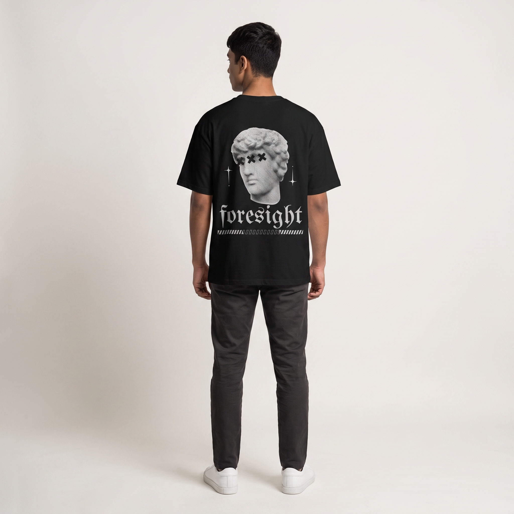 Model wearing Foresight oversized t-shirt, back view showing back print