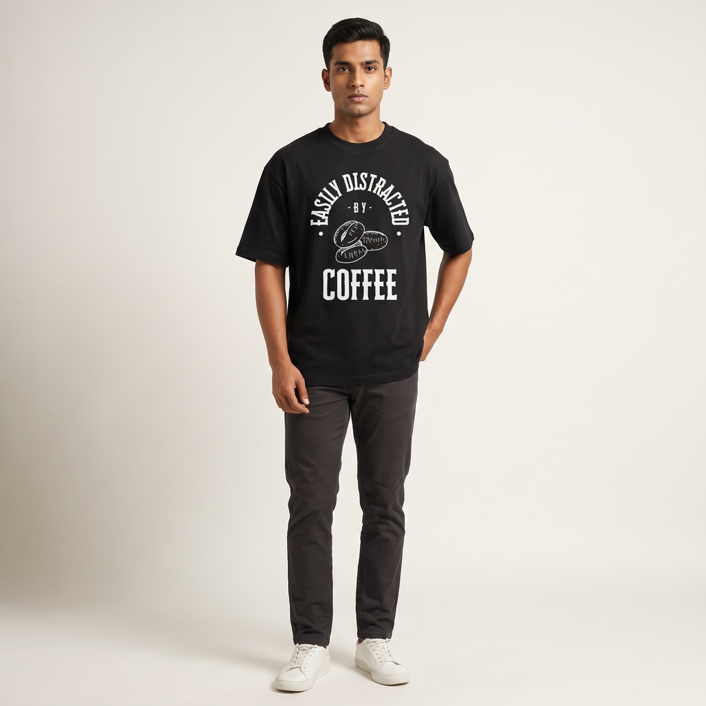 Model wearing Distracted by Coffee Dark oversized t-shirt, front view showing chest print