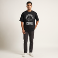 Model wearing Distracted by Coffee Dark oversized t-shirt, front view showing chest print