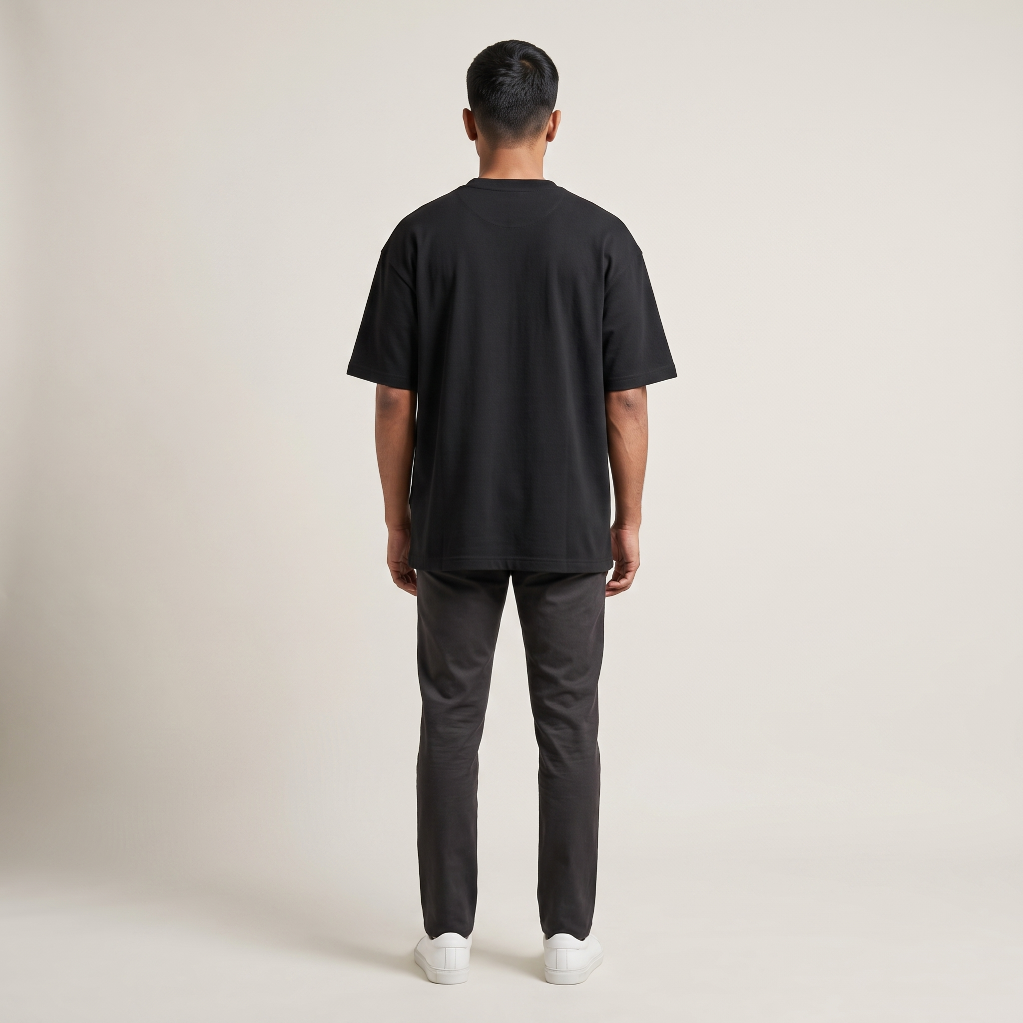 Model wearing Straight Outta 90s oversized t-shirt, back view