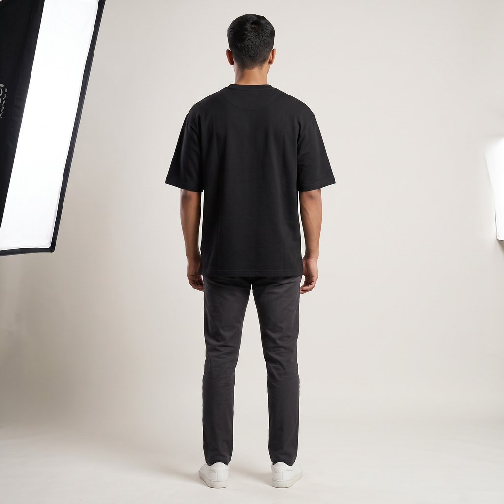 Model wearing Hustle for the Muscle oversized t-shirt, back view