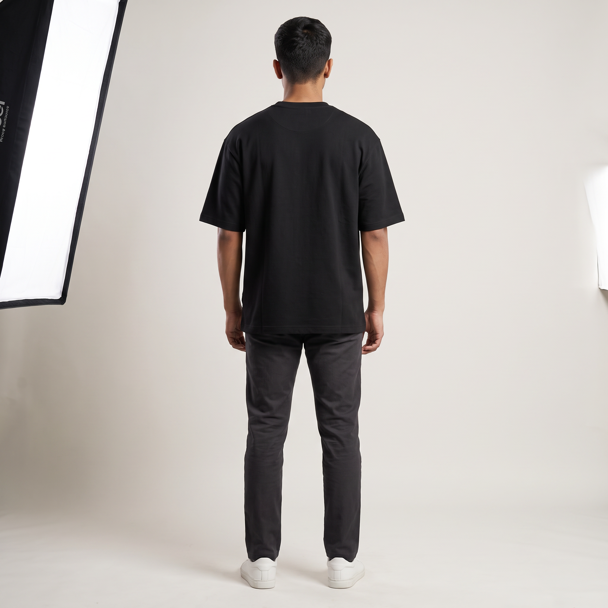 Model wearing Hustle for the Muscle oversized t-shirt, back view