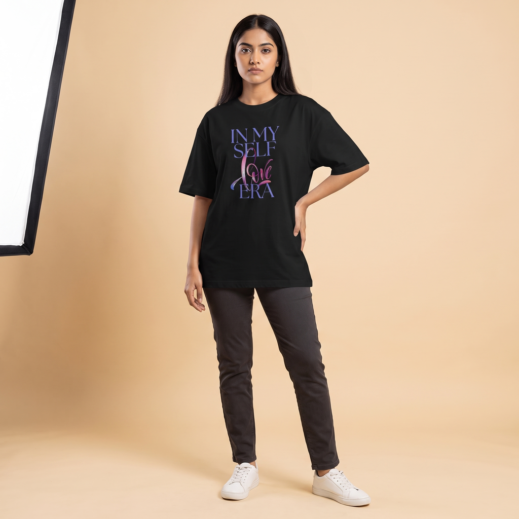 Female model wearing Self Love Era oversized t-shirt, front view showing chest print