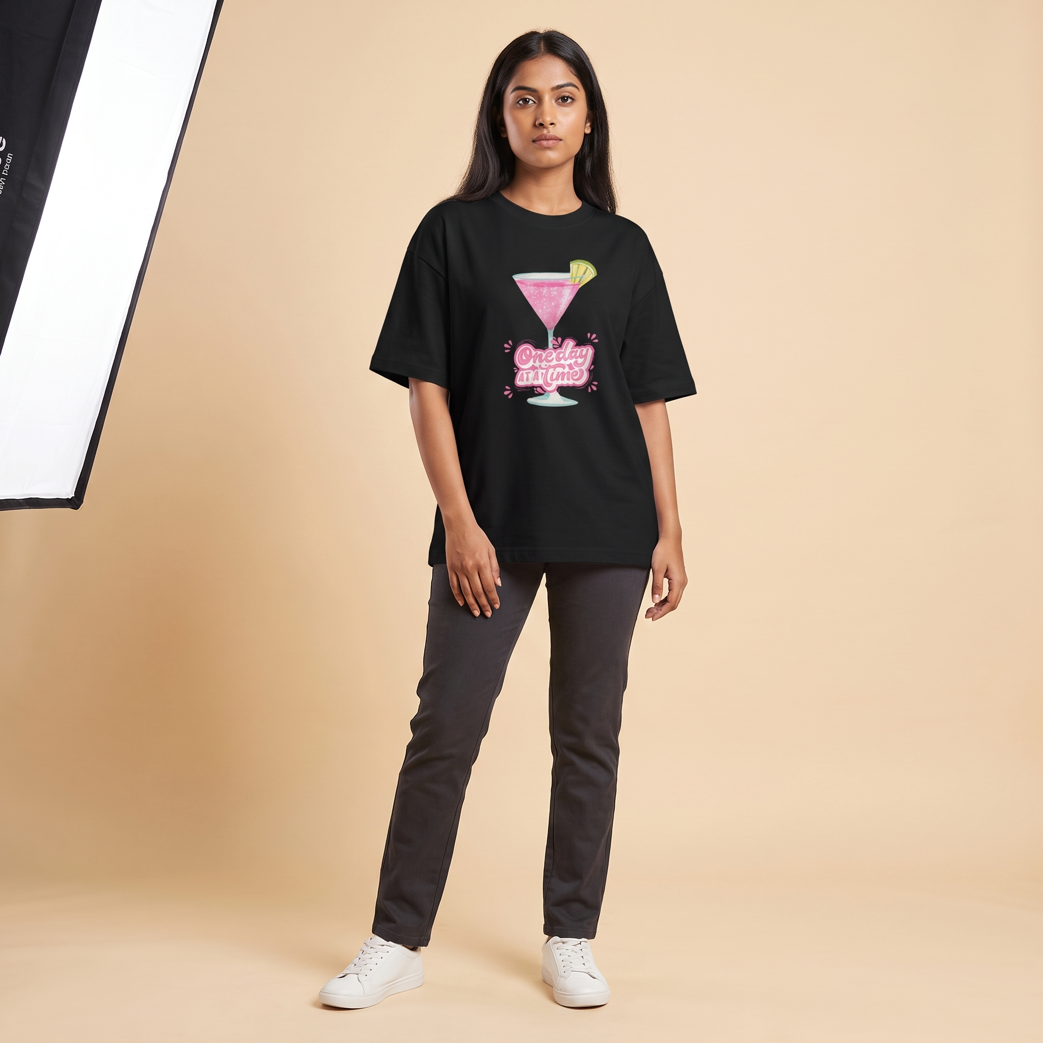 Female model wearing Cosmo oversized t-shirt, front view showing chest print