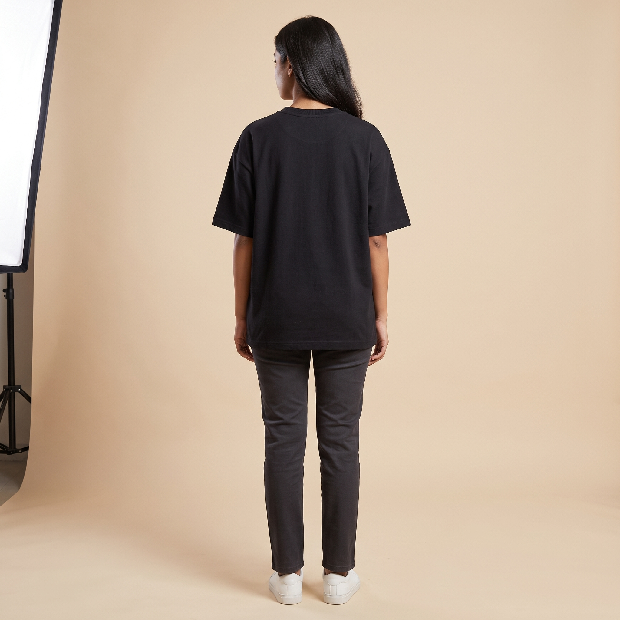 Female model wearing Cosmo oversized t-shirt, back view
