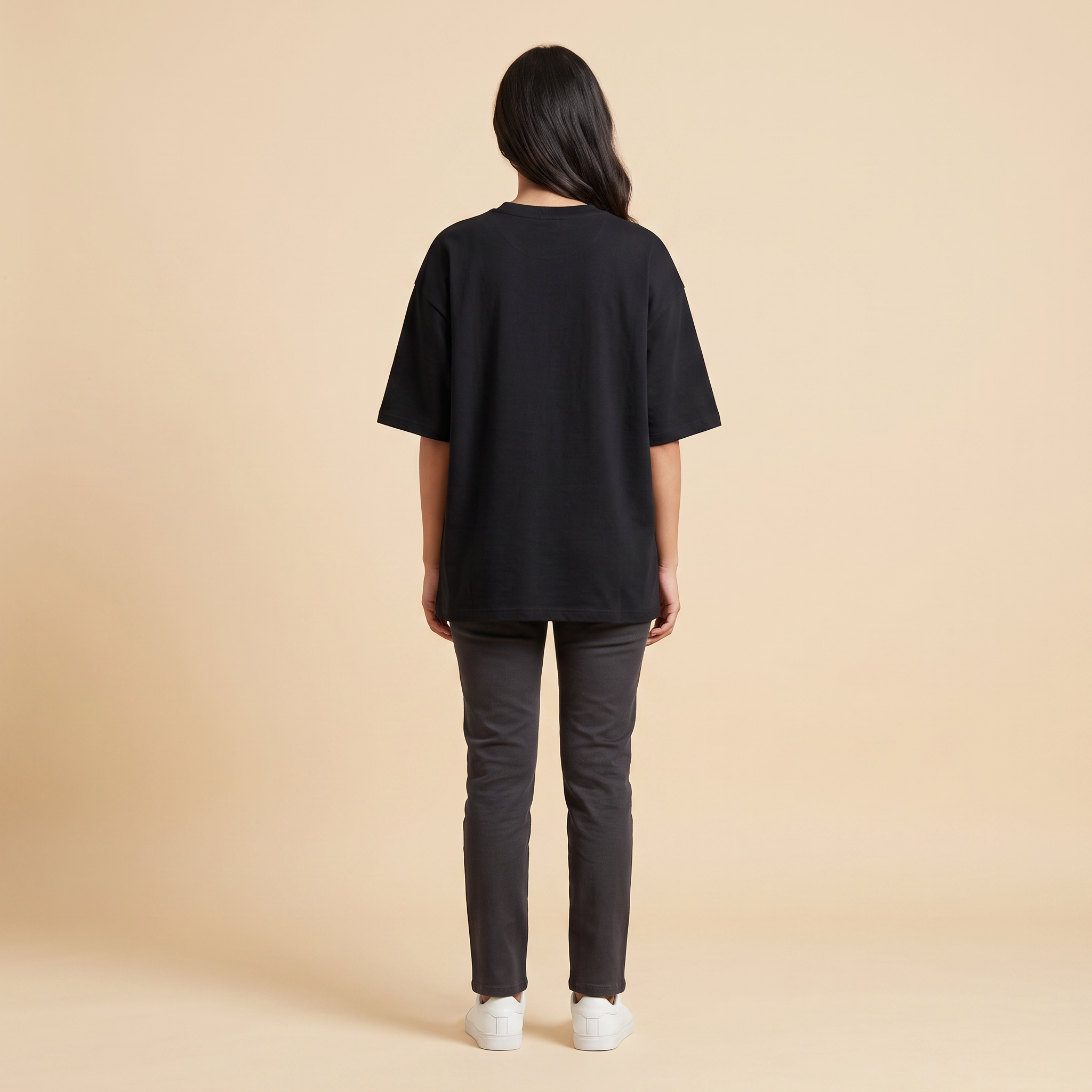 Female model wearing Embrace The Chaos oversized t-shirt, back view