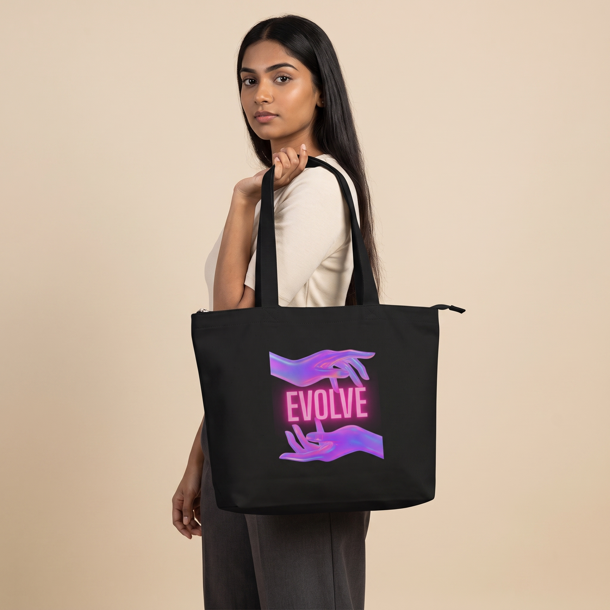 Model carrying Evolve zippered large tote bag in black canvas, front print visible