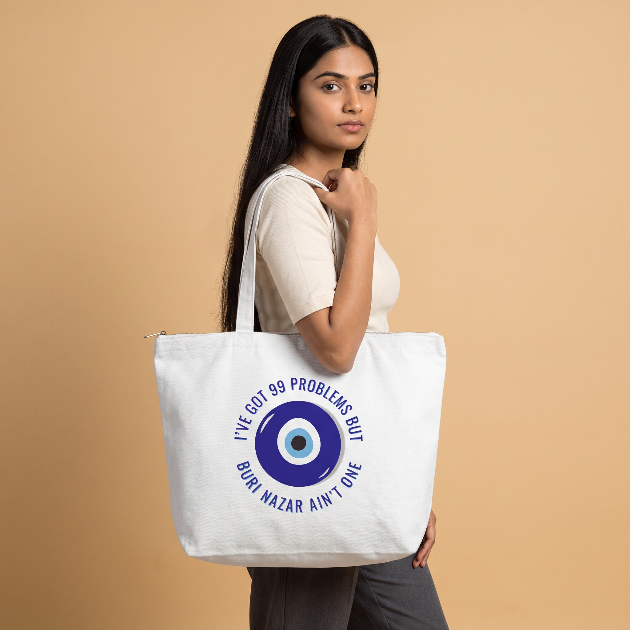 Model carrying Buri Nazar zippered large tote bag in white canvas, front print visible