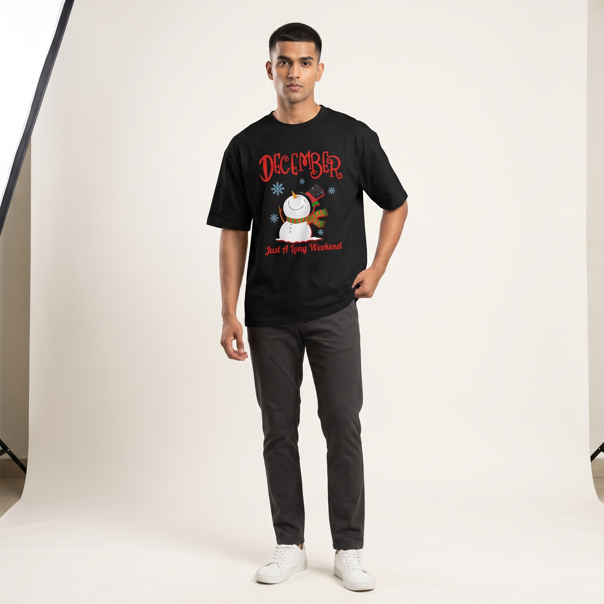 Model wearing December A Long Weekend oversized t-shirt, front view showing chest print